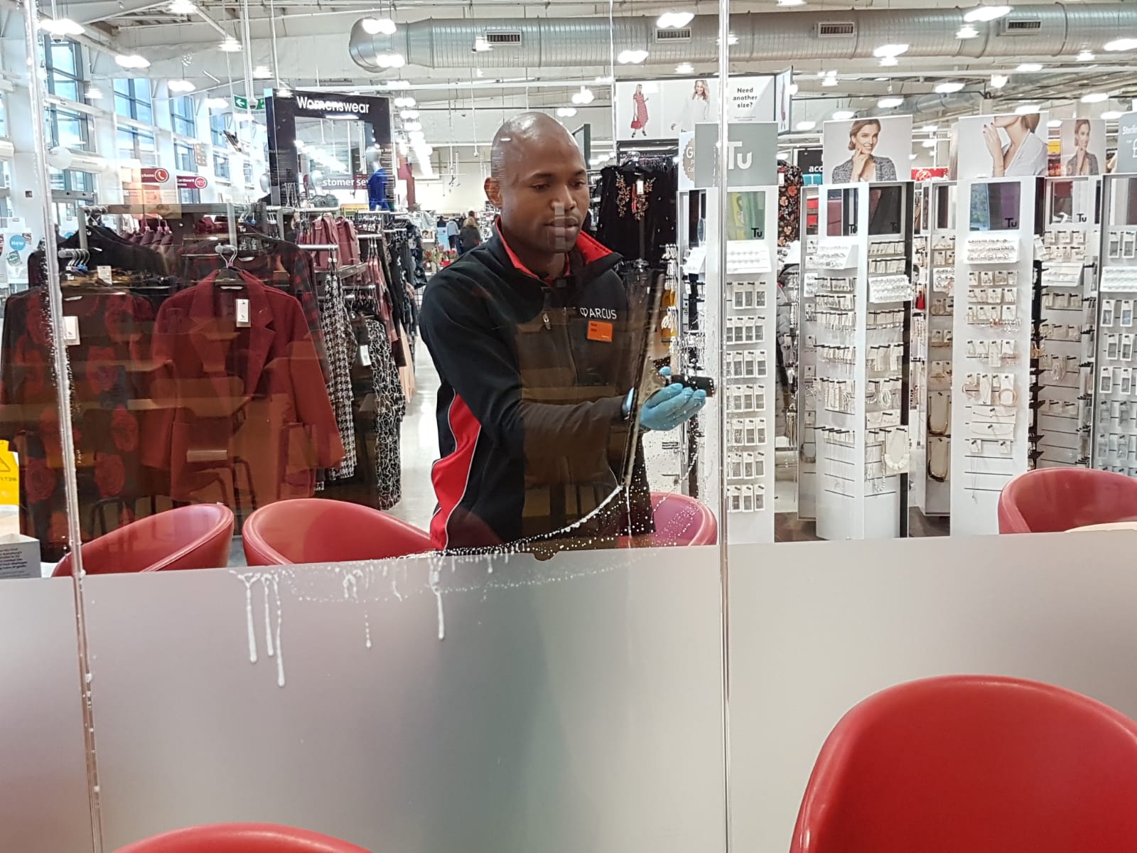 Arcus FM Commercial Cleaner, cleaning window at Sainsbury's.