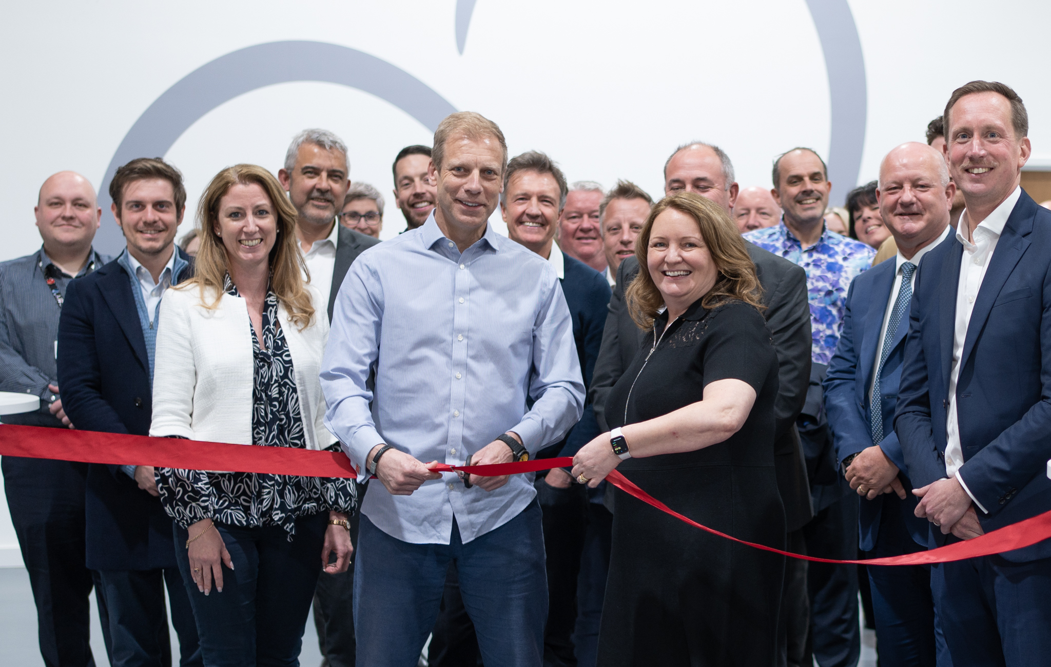 CEO Chris Green cuts the opening ribbon in front of the Arcus FM Senior Leadership Team